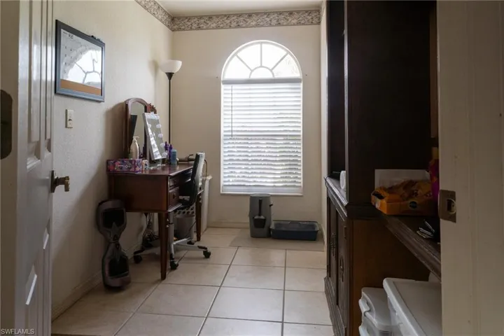 Bonus room off the kitchen with built-in cabinetry