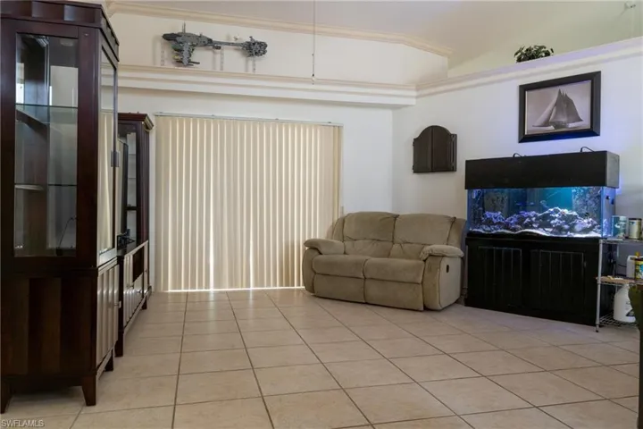 Spacious living room with sliders to the lanai and pool
