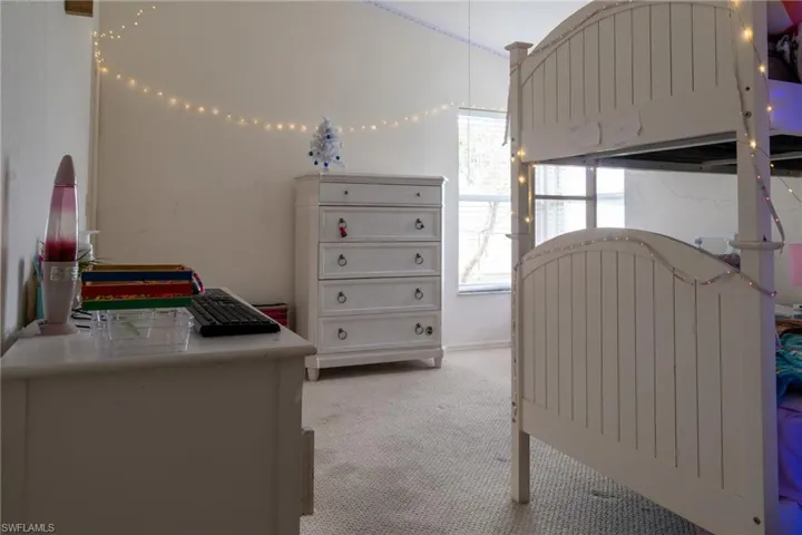 Bedroom featuring light colored carpet