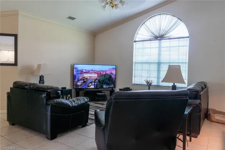 Living room with vaulted ceilings and crown