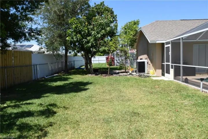 Fenced yard with mango tree
