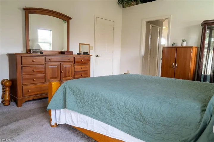 Primary bedroom with slider to the lanai and pool