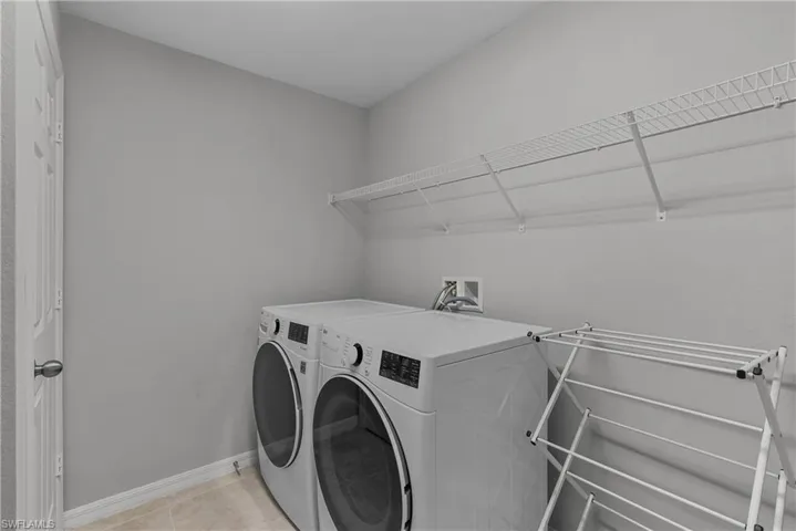 Spacious laundry room with closet and shelving