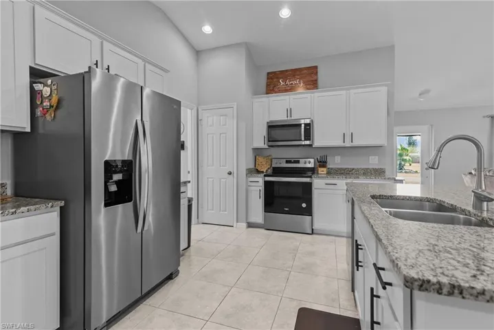 Kitchen with granite countertops, stainless steel appliances, plenty of cabinets, and pantry