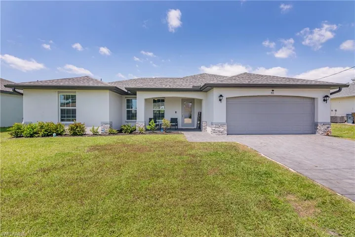 Front Elevation with charming front porch and paver driveway