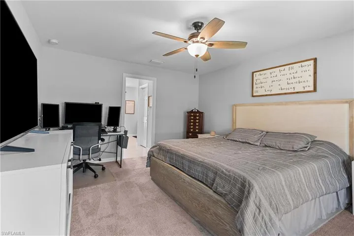 Spacious master bedroom has plenty of space for extra furniture, including an entire workspace!