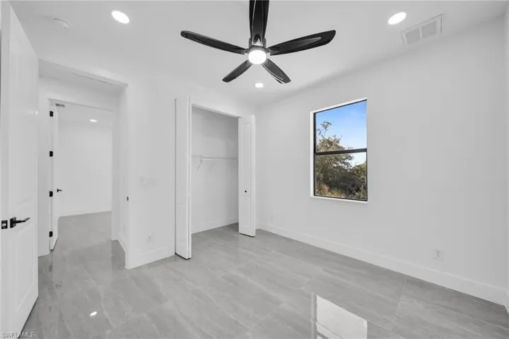 Unfurnished bedroom with ceiling fan, recessed lighting, and a closet