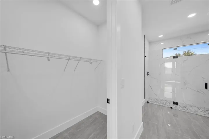 Laundry area with baseboards and recessed lighting