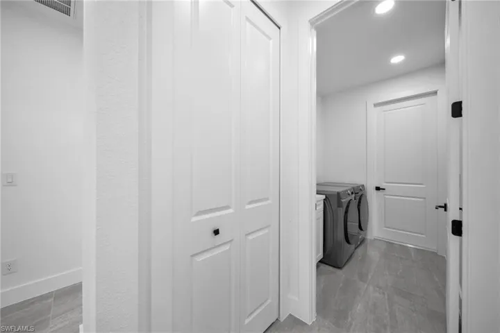 Laundry room featuring washer and dryer and recessed lighting