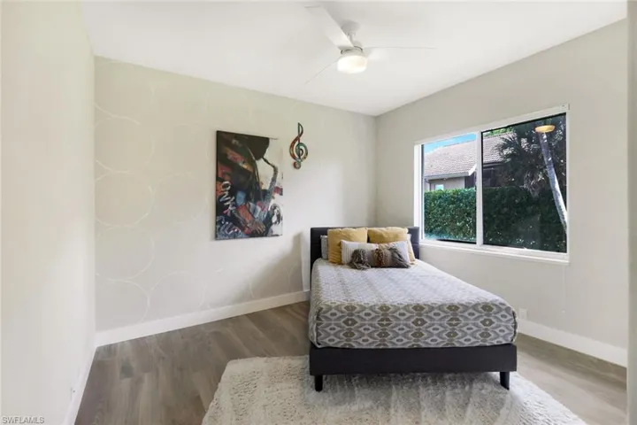 Bedroom featuring hardwood / wood-style floors and ceiling fan