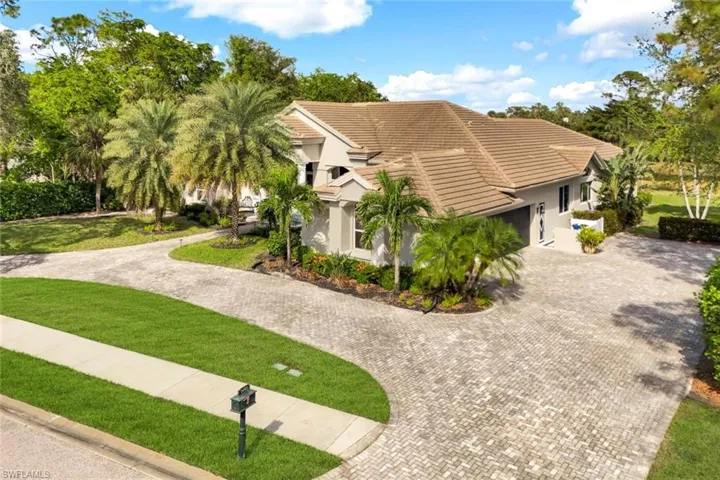 View of side of home featuring a yard and a garage