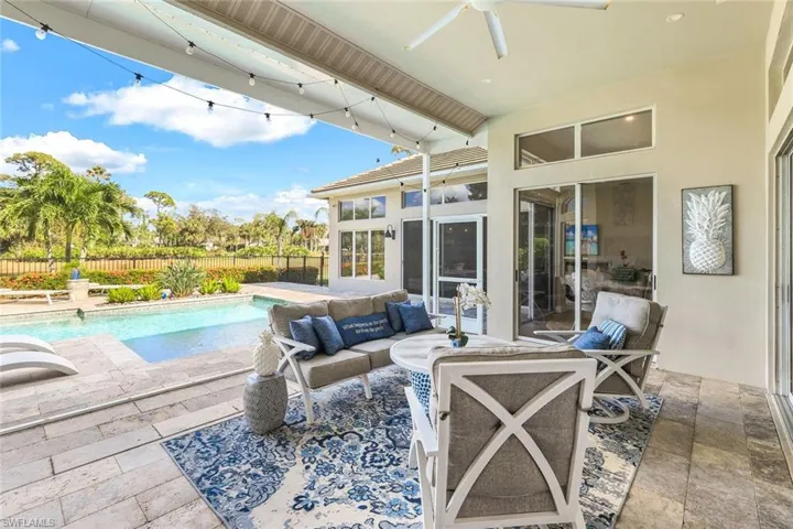 View of patio featuring a fenced in pool, ceiling fan, and an outdoor living space