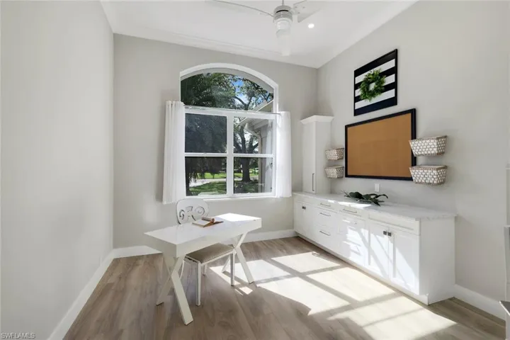 Home office featuring ceiling fan, light hardwood / wood-style flooring, and crown molding