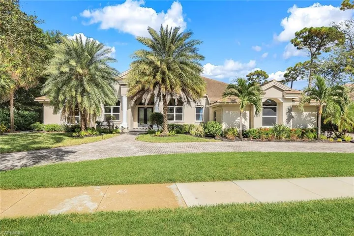 Mediterranean / spanish house with a front yard