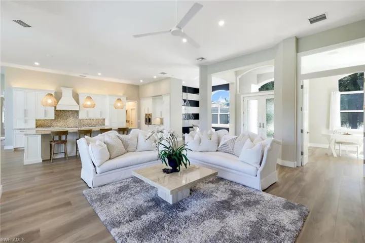Living room with ceiling fan and light wood-type flooring