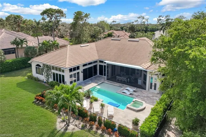 View of swimming pool featuring an in ground hot tub, a patio area, and a lawn