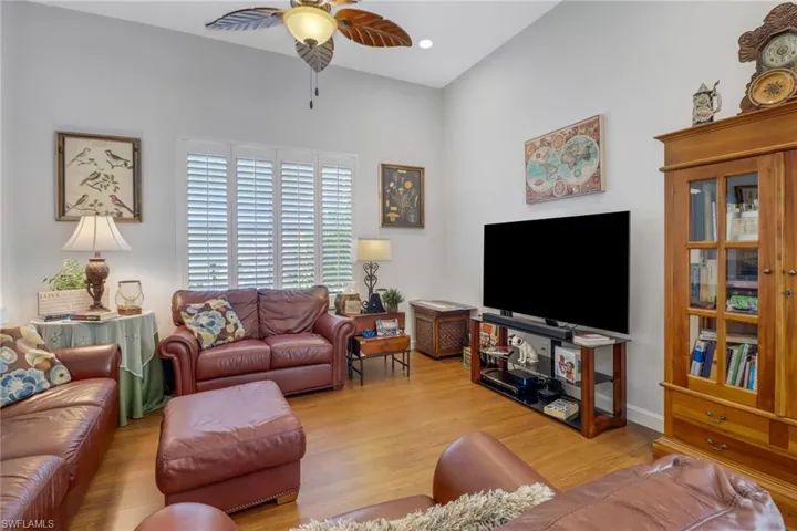 Living room with ceiling fan and light wood-type flooring