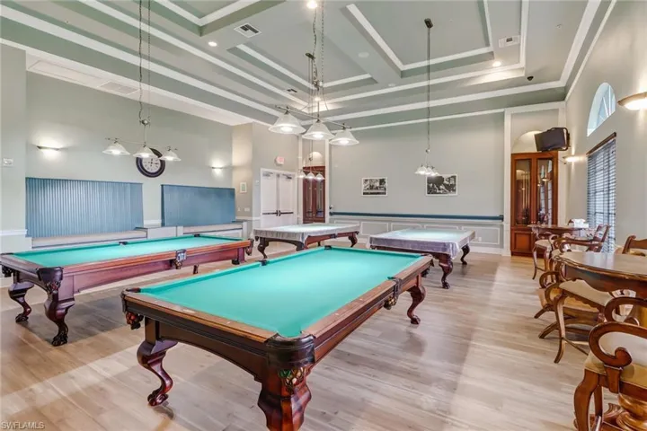 Game room featuring light wood-type flooring, a high ceiling, coffered ceiling, and billiards