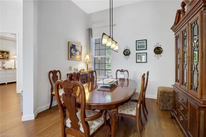 Dining space with wood-type flooring and a high ceiling