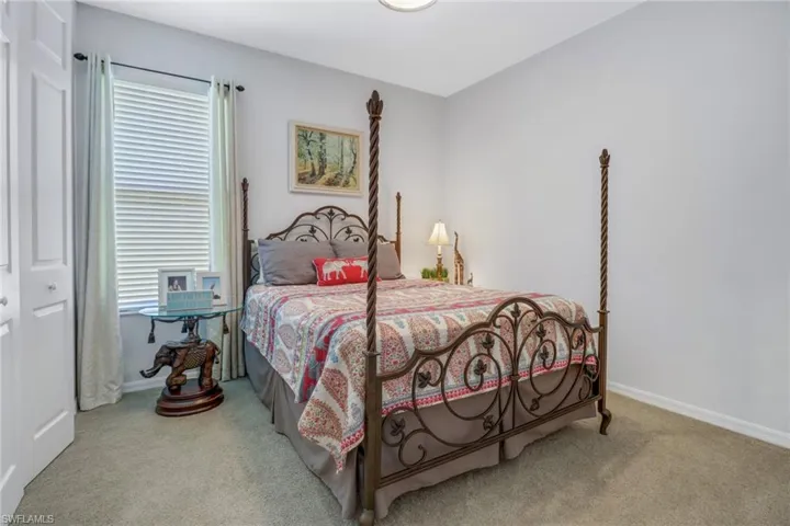 Carpeted bedroom with a closet