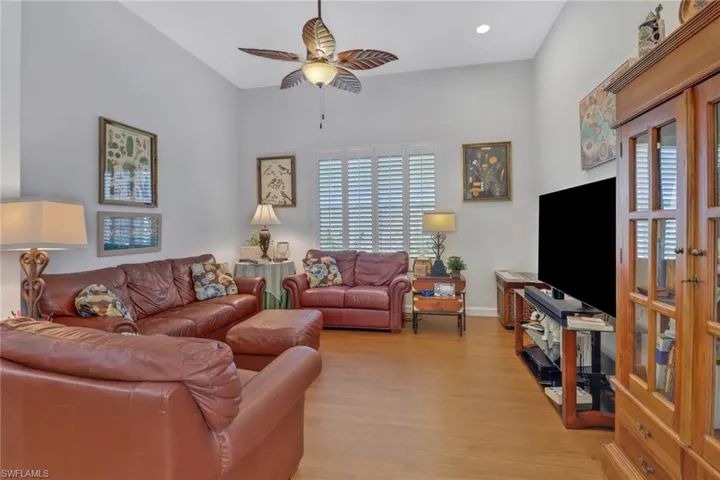 Living room featuring ceiling fan, light wood-type flooring, and plenty of natural light