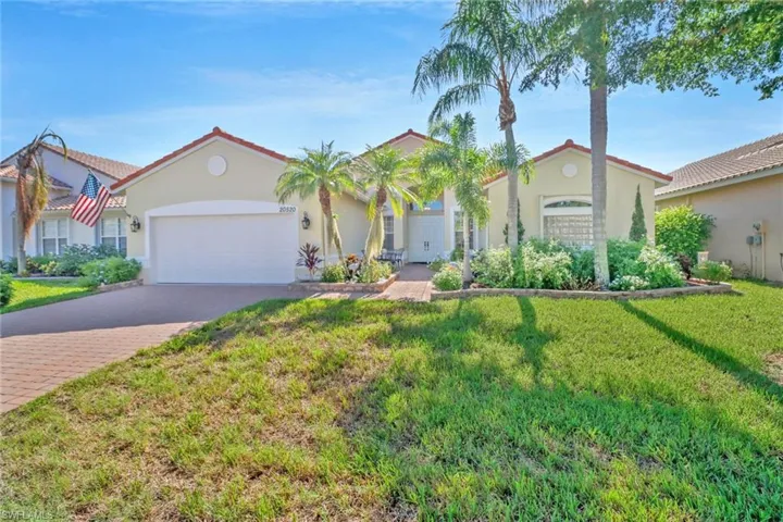 View of front of property featuring a garage and a front yard