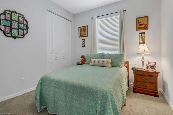 Carpeted bedroom featuring a closet