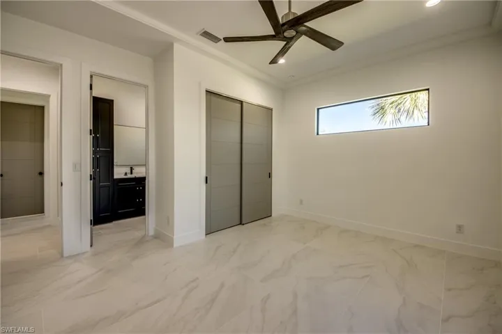 Unfurnished bedroom with a closet, crown molding, and ceiling fan
