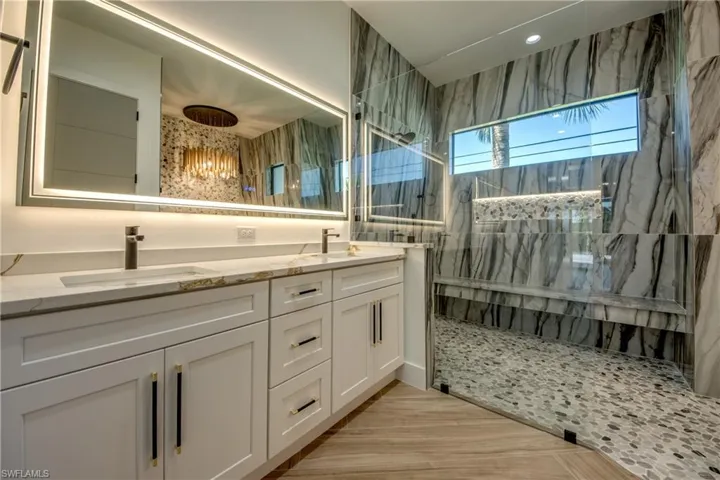 Bathroom with vanity and tiled shower
