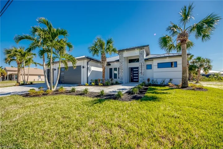 View of front of home featuring a garage and a front yard