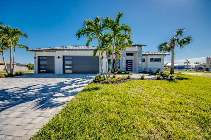 View of front of house featuring a front yard and a garage