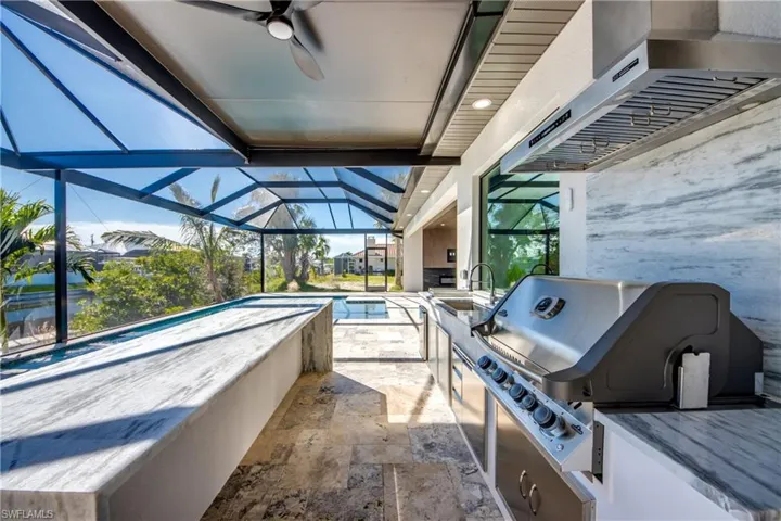 View of patio with a grill, ceiling fan, a swimming pool, and a lanai