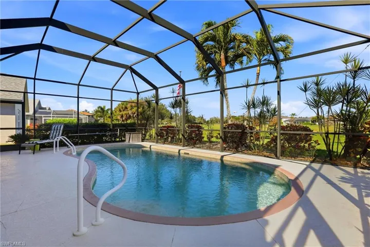Swimming pool featuring glass enclosure and a sunroom