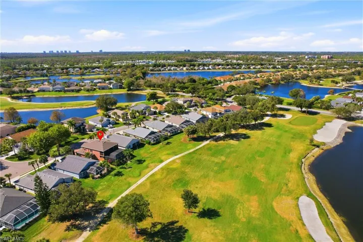 Aerial view of property's location featuring a large body of water and nearby suburban area