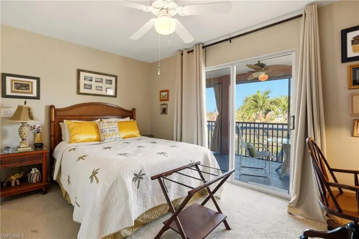 Bedroom with access to exterior, ceiling fan, and light carpet