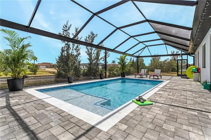 Pool with a patio area and a lanai