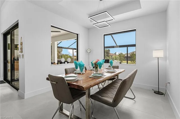 Dining room with baseboards and a raised ceiling