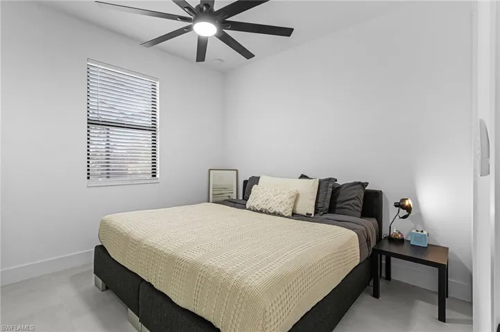 Bedroom with baseboards and a ceiling fan