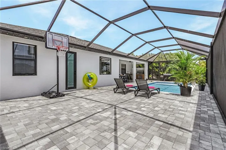 View of patio featuring a lanai and an outdoor pool