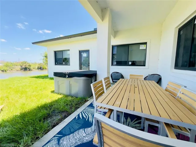View of patio / terrace featuring outdoor dining area and a hot tub