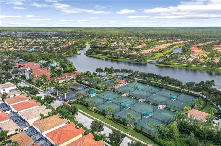 Expansive community featuring multiple tennis courts, a large central lake, and extensive residential development