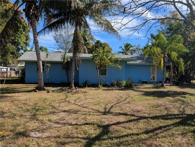 View of side of home with a yard
