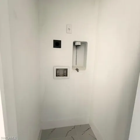 Laundry area with washer hookup and hookup for an electric dryer