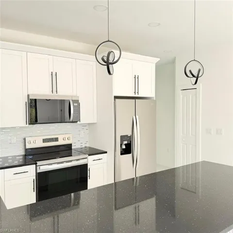 Kitchen with stainless steel appliances and white cabinetry