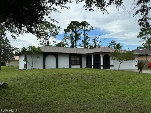 Ranch-style house with a garage and a front yard
