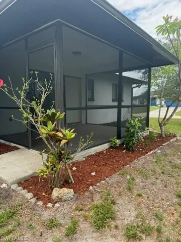 View of property exterior featuring a sunroom