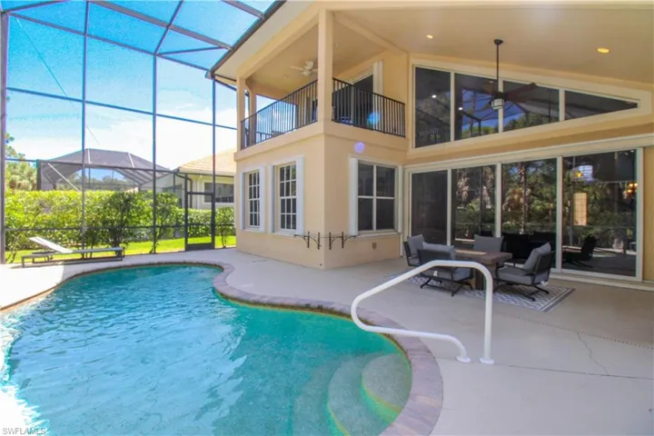 View of pool with a lanai and a patio area