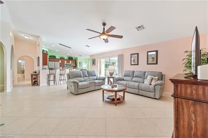 Tiled living room featuring ceiling fan