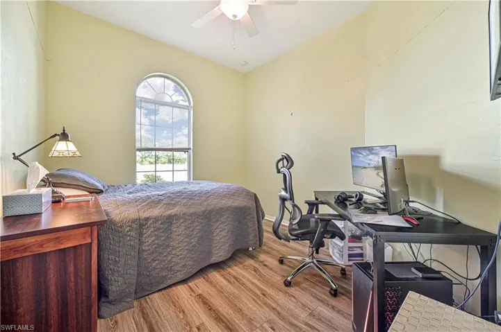 Bedroom with light hardwood / wood-style flooring and ceiling fan