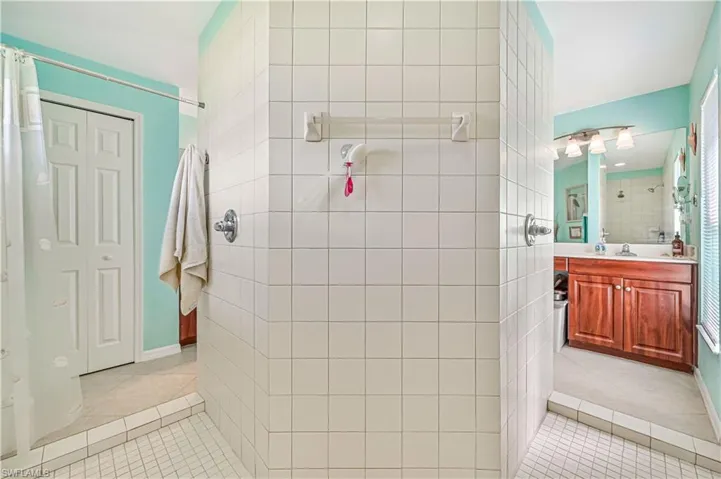 Bathroom with vanity, tile floors, and tiled Walk-in Double shower for two.